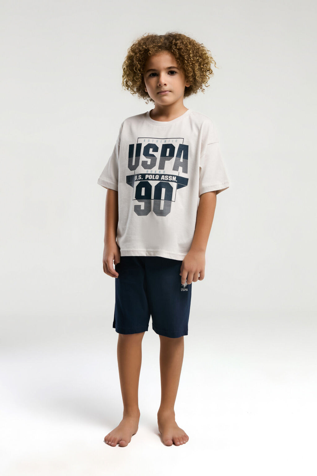 U.S. Polo Assn. Erkek Çocuk Bisiklet Yaka Pigment Baskılı Yazlık Regular Fit Krem Bermuda Takım US2024-C-V1