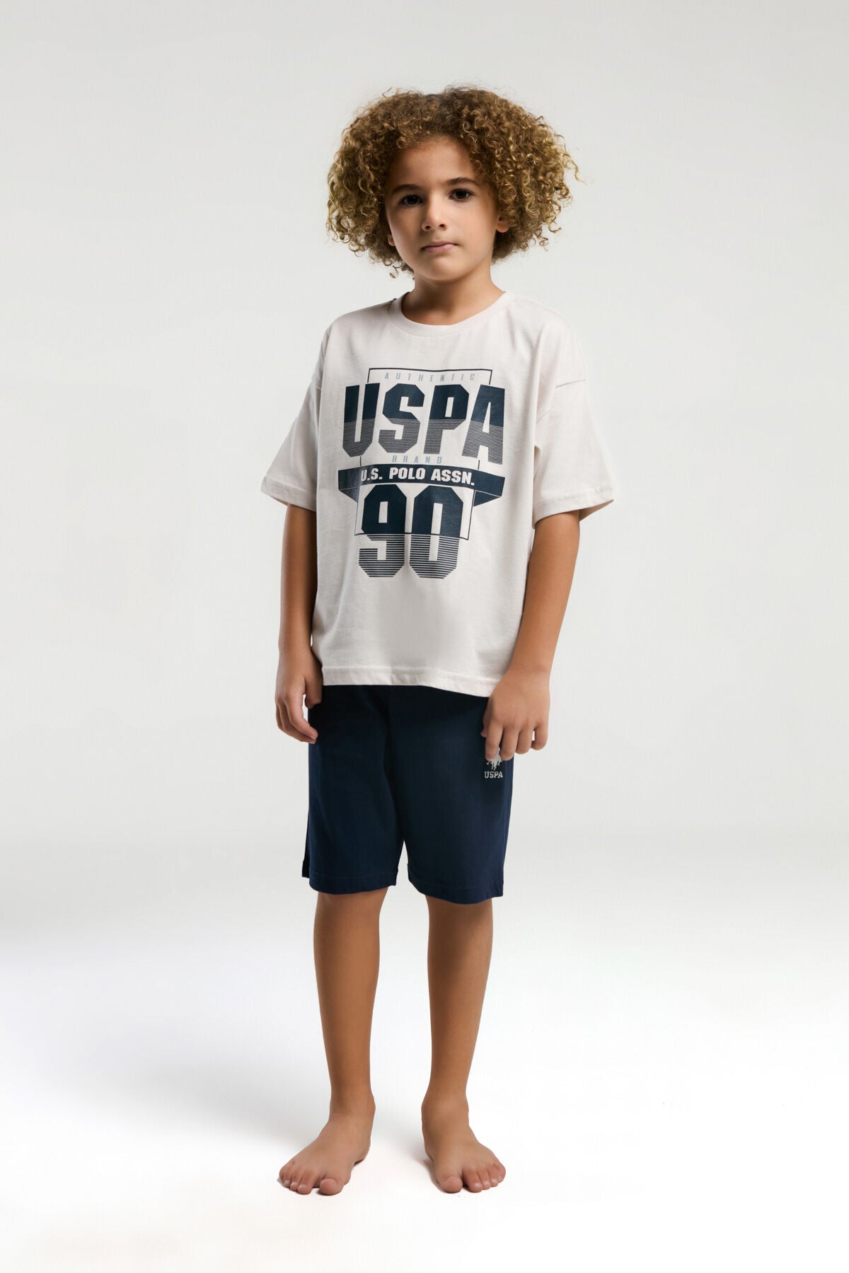 U.S. Polo Assn. Erkek Çocuk Bisiklet Yaka Pigment Baskılı Yazlık Regular Fit Krem Bermuda Takım US2024-C-V1